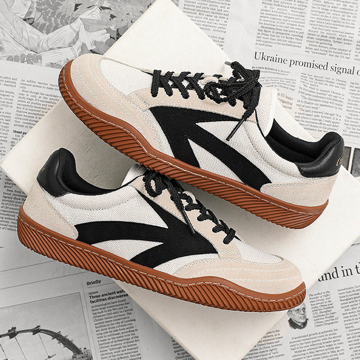 White sneakers with black and brown accents on a newspaper background