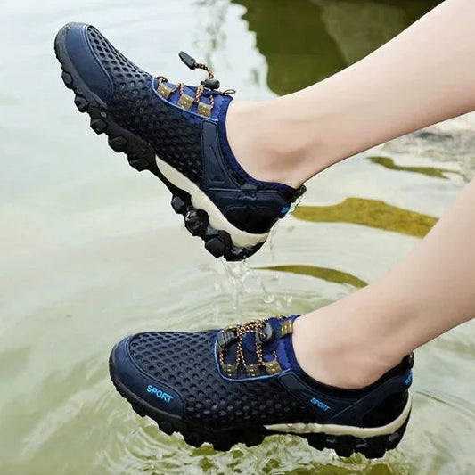 Person wearing blue water shoes stepping into water