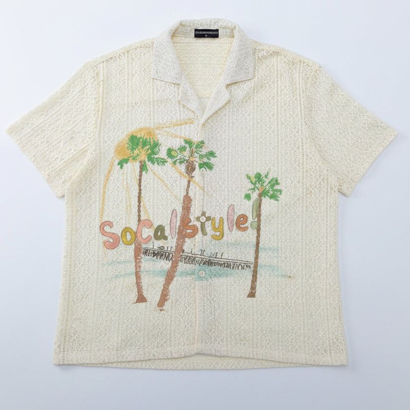 A cream-colored short-sleeve camp collar shirt with a textured knit pattern, featuring a graphic print of palm trees and the words 'Social Style!' in pastel colors.
